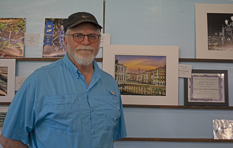Photo of Best of Photography winner Bobby Strader standing next to his photo.