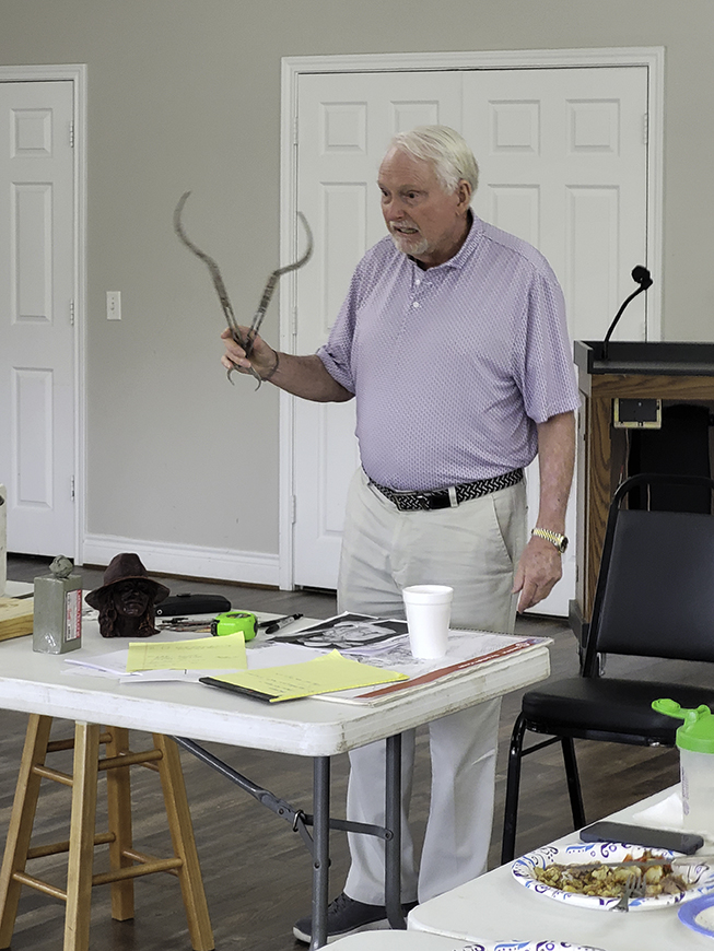 Photo of Robert holding up a pair of calipers.